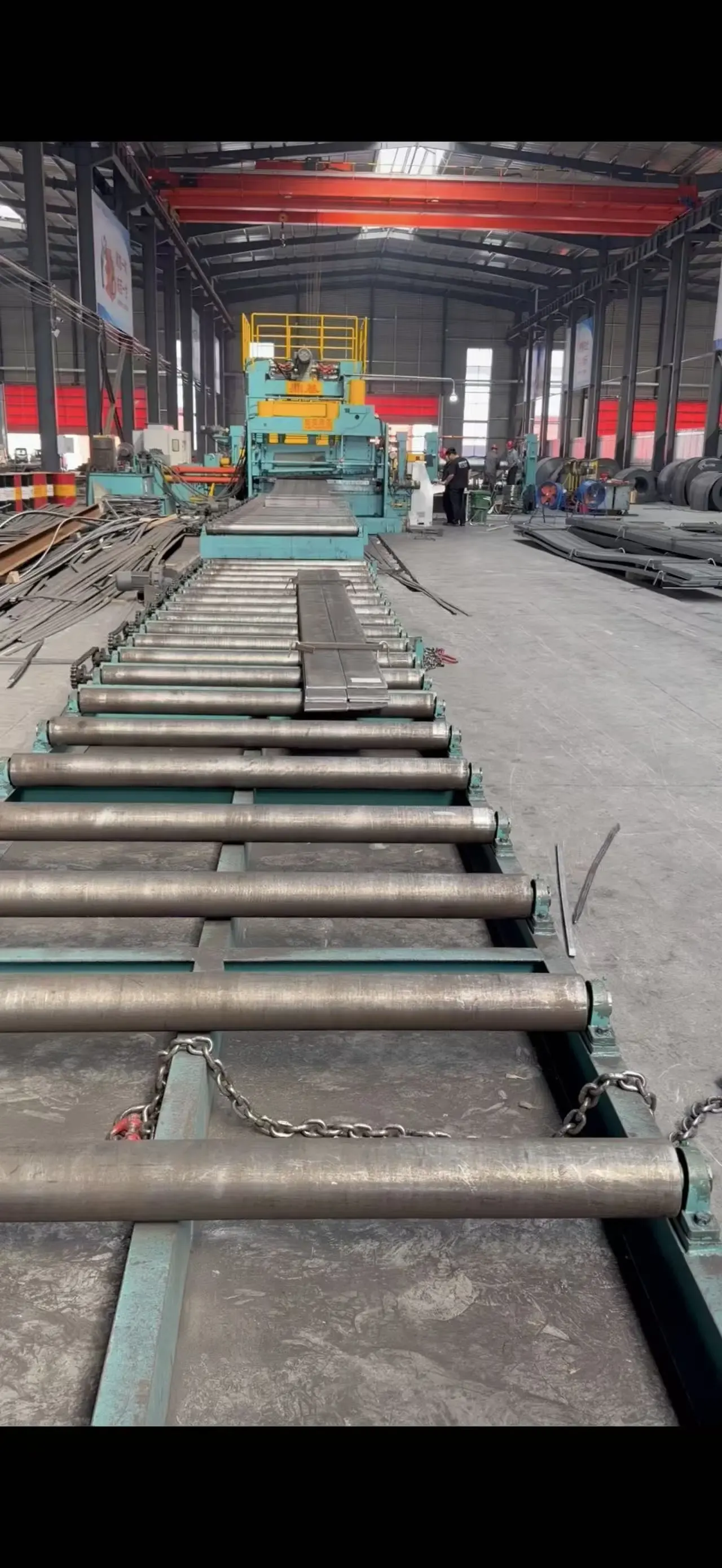 Roller conveyor system for automated steel processing line